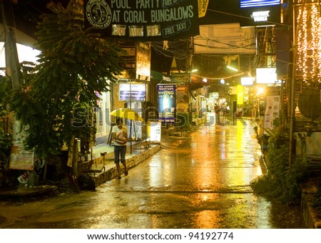 KOH PHANGAN, THAILAND - MARCH 22: Night street in the rain on March 22, 2011 in Koh Phangan. It is famous for its full moon party at Haad Rin Beach. Area: about 168 km with population about 12000