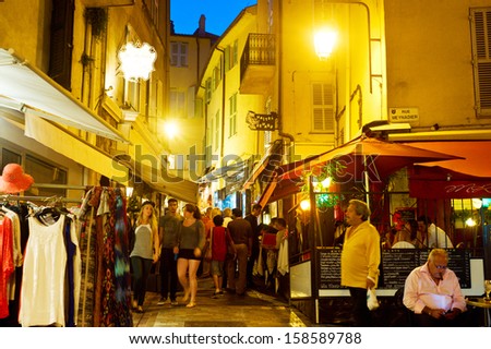 CANNES - SEPTEMBER 15: Tourists visit local shops in Cannes old city center on September 15 2013. Currently the city is hosting Festival of chefs.