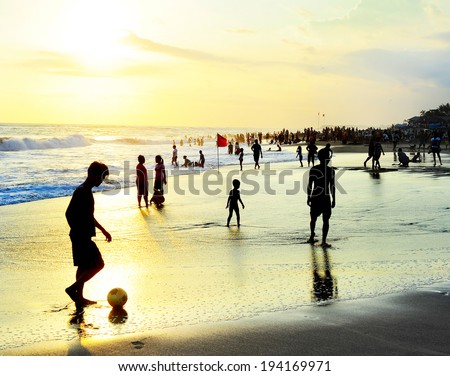 KUTA, INDONESIA - MAY 05,2013: Unidetified people plaing soccer on the beach in Kuta, Indonesia. Football is the most popular sport in Indonesia. The Indonesian football league started around 1930