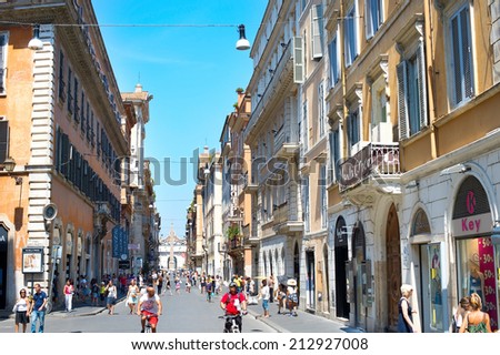 ROME, ITALY - AUGUST 10, 2014: Tourists walking on the Old Town street of Rome. More than 6 million of international tourists visit Rome every year.
