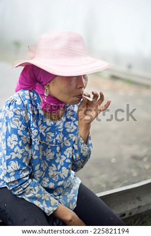 PROBOLINGO, INDONESIA - APRIL 24,2011: Unidentified indonesian woman smoking  cigarette. Smoking in Indonesia is a common practice, as over 165 million people smoke in Indonesia.