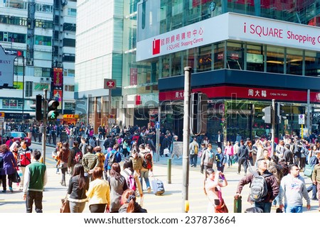 HONG KONG - JAN 19, 2013: People crosing the street in Hong Kong. With a land mass of 1,104 km and population of 7 million people, Hong Kong is one of the most densely populated areas in the world