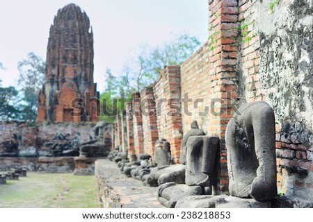 A row of Buddha statues without head in Ayutthaya historical park, Ayutthaya , Thailand