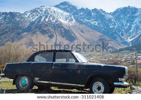 Retro soviet car and mountains on the background. Georgia