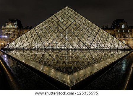 PARIS - NOV 09 : View of the Louvre Pyramid and Pavillon Richelieu in the evening, Nov 09, 2012, Paris, France. The pyramid serves as the main entrance to the Louvre Museum