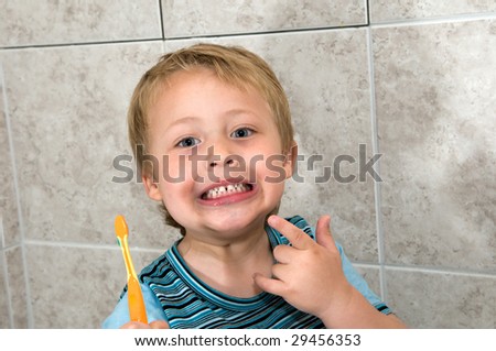 A small boy shows how he has a good clean teeth