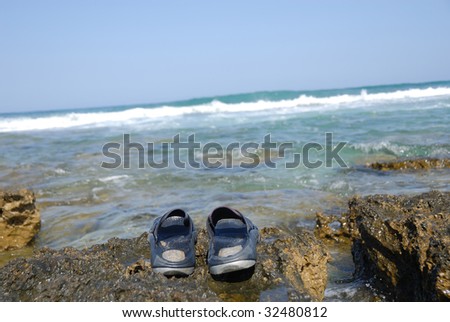 people went to bathe in the sea left the slippers on rocks on the shore