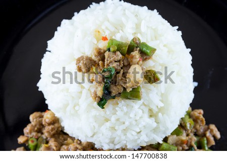image of Fried basil leave with pork on rice is popular food of the thailand