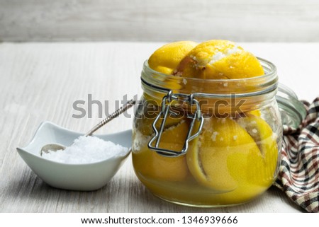 Similar – Image, Stock Photo Fermented lemons in jars of salt, chili pepper and rosemary. Probiotics Fermented food. Pickled lemons.
