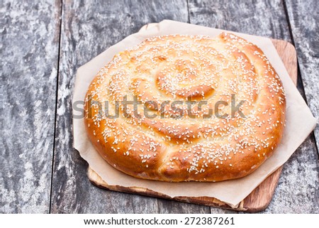 homemade white spiral bread with cheese on the old table