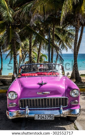 VARADERO, CUBA - JUNE, 22 2015: HDR Pink american classic car on the beach