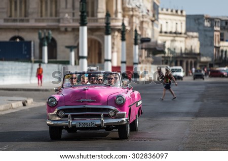 HAVANA, CUBA - JULY 05, 2015: Pink  american cabriolet classic car drives in Havana City