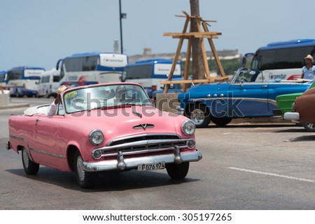 HAVANA, CUBA - JULY 05, 2015: Propelled pink cabriolet  vintage car on the Malecon in Havana
