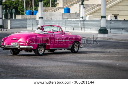 HAVANA, CUBA - JULY 05, 2015: Pink vintage cabriolet drives on the Street in Havana City
