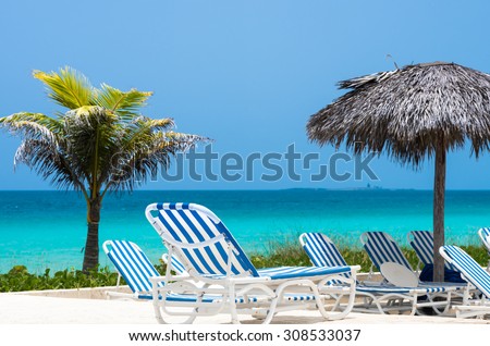 Cuba sun lounger with hut and horizon view of the ocean