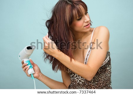Young woman with hair dryer