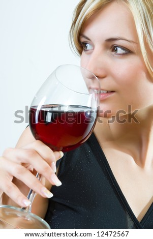 Young woman drinking red wine - white background