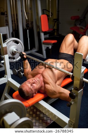 Muscular man with dumbbell in home fitness