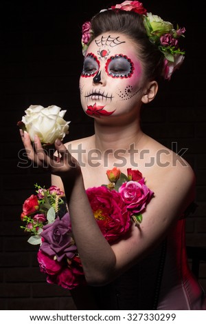 halloween make up sugar skull beautiful model with perfect hairstyle. Santa Muerte concept. motion effect, blur effect