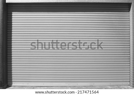 grunge metallic roller white shutter door at night