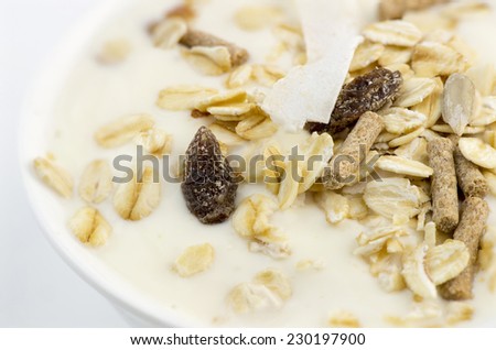 Macro closeup of delicious low-fat yogurt with oats, muesli, bran, almonds and dehydrated fruit
