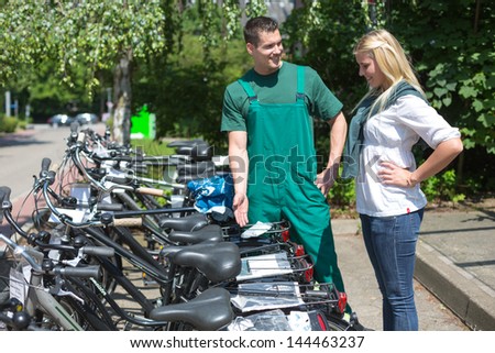 Bicycle presenting a collection of new bikes to customer in cycle shop