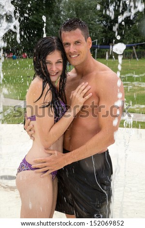 Couple in love at water park in public swimming pool