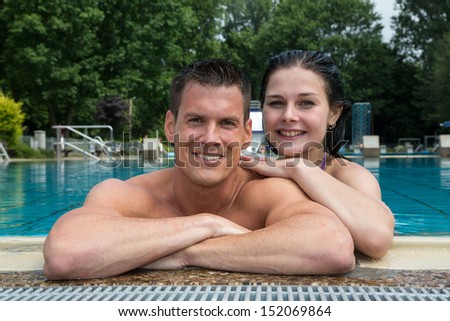Couple enjoying summer at public swimming pool