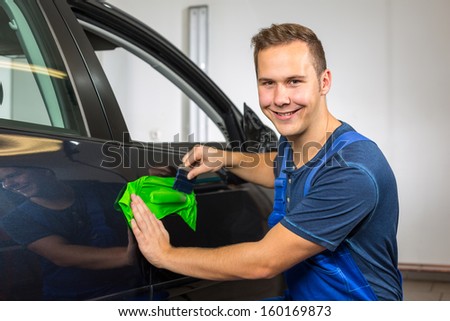 car wrapping professional wrapping car door handle in colorful foil or film using a squeegee