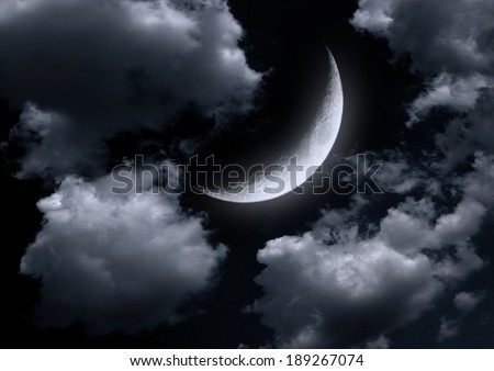 The moon in the night sky in clouds \