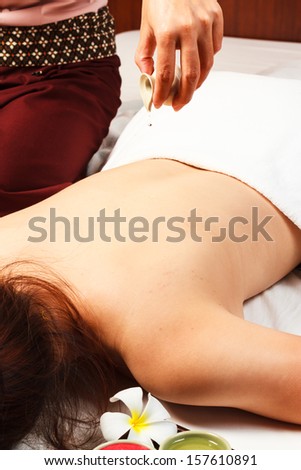 woman having a massage with massage oil in a spa