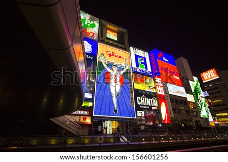 OSAKA, JAPAN - NOVEMBER 29 : Japanese people wander in Dotonbori area of Osaka after work on November 29 2012. Dotonbori is an entertainment area of Osaka famous for its neon signs.