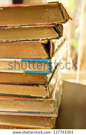 Stack of old books row background in library