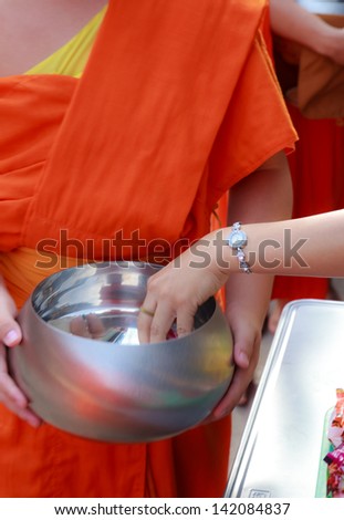 PHRAE, THAILAND - OCT 31 : Unidentified Buddhist monks are given food offering from people in the morning for End of Buddhist Lent Day. on October 31, 2011 in Muang, Phrae, Thailand.