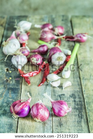 Close up onions,garlic,dry pepper and lemon grass on wooden table