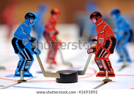Red and blue figures of hockey players of children\'s board game