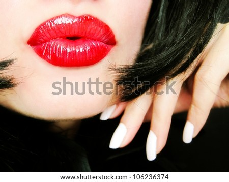 Sexy pretty woman with red lips sending a kiss / smooch - closeup