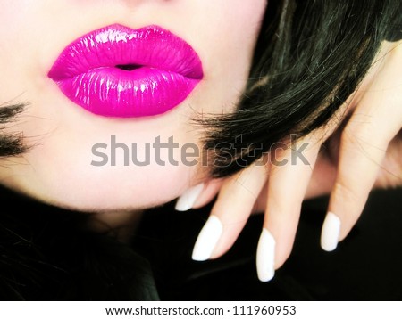 Sexy young pretty woman with pink lips sending a kiss / smooch - closeup