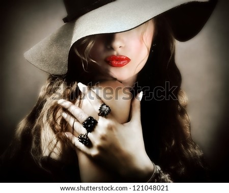 Sexy young pretty woman / model with red lips, vintage / retro hat and jewelry is sending a kiss / smooch - closeup