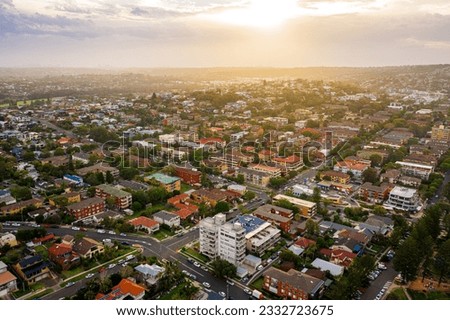 Similar – Image, Stock Photo Aerial view over a little town with wind wheels and a lake in the background of a german countryside.