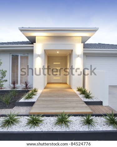 Facade and entry to a contemporary white rendered home in Australia - vertical