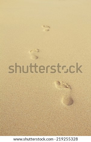 Background of footprints in sand on a beach
