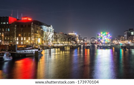 AMSTERDAM, NETHERLANDS - DECEMBER 14: Carre and the skinny bridge at night, during the second edition of the Amsterdam Light Festival on December 14, 2013 in Amsterdam.