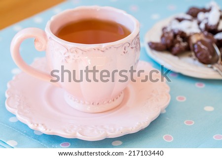 Close up of a cup of tea and chocolate candies