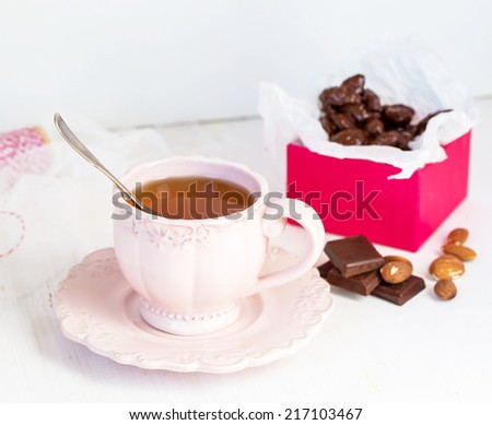 Close up of a cup of tea and chocolate candies
