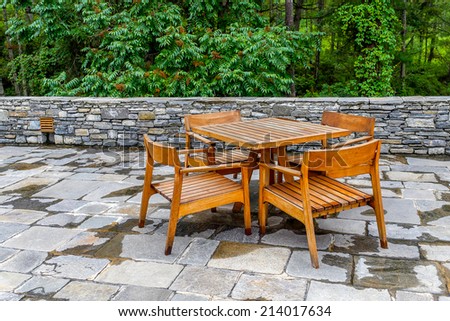 a wooden dining table set in garden