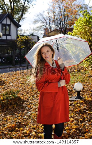 Young beautiful woman in the park in a fashion shot,  looking away and smiling - caucasian woman, autumn, fall, park