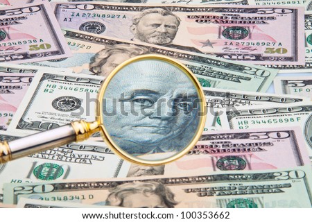 many dollar bills photographed with a magnifying glass. close up