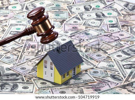 dollar currency notes, gavel and model building. housing crisis in america