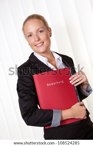 a woman in business attire with a job application. proper clothing for the interview.